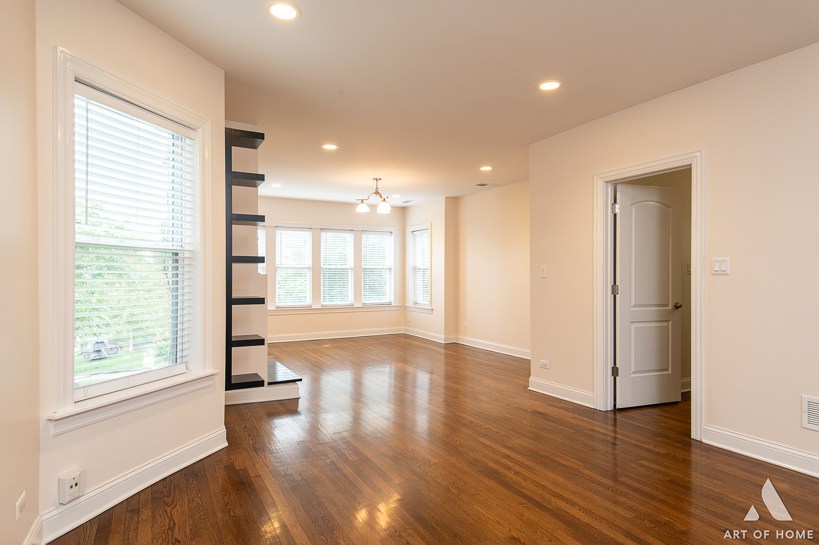 4820 West George Street, Unit 2 Chicago, IL 60641 - Photo 4 of 24 a view of an empty room with wooden floor and a window