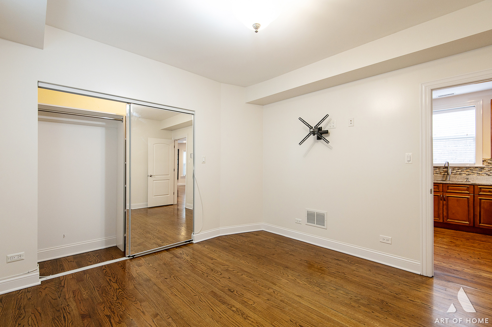 4820 West George Street, Unit 2 Chicago, IL 60641 - Photo 10 of 24 an empty room with wooden floor and cabinet