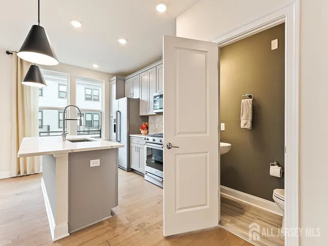 a kitchen with stainless steel appliances granite countertop a refrigerator and a stove top oven