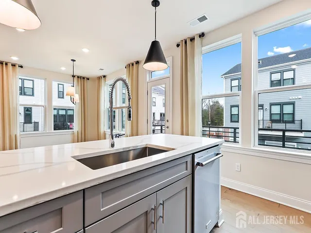 a view of a kitchen with a sink and chandelier