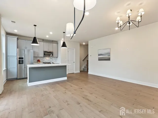 a view of kitchen with refrigerator and window