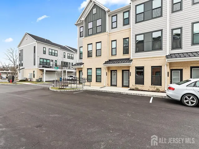 a front view of a building with parking space