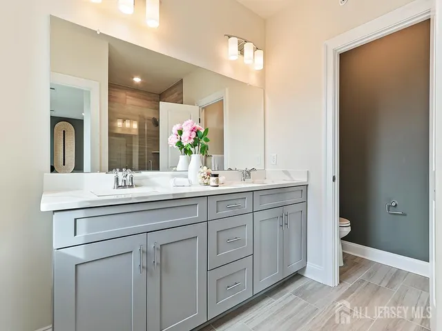 a bathroom with a double vanity sink and a mirror