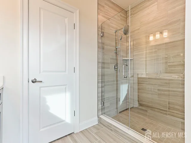 a bathroom with a glass shower door