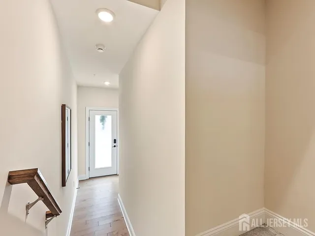 a view of a hallway with wooden floor
