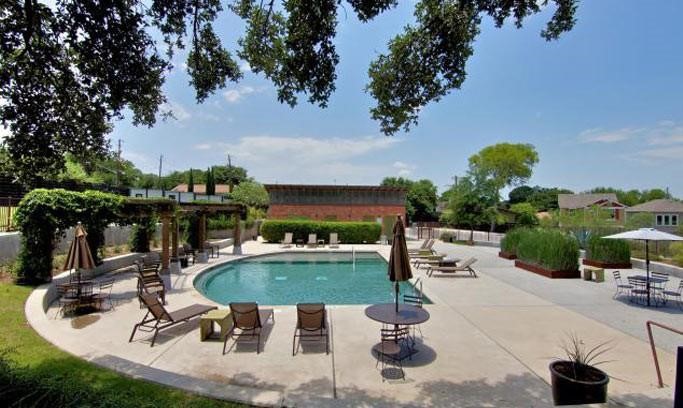 a swimming pool with outdoor seating