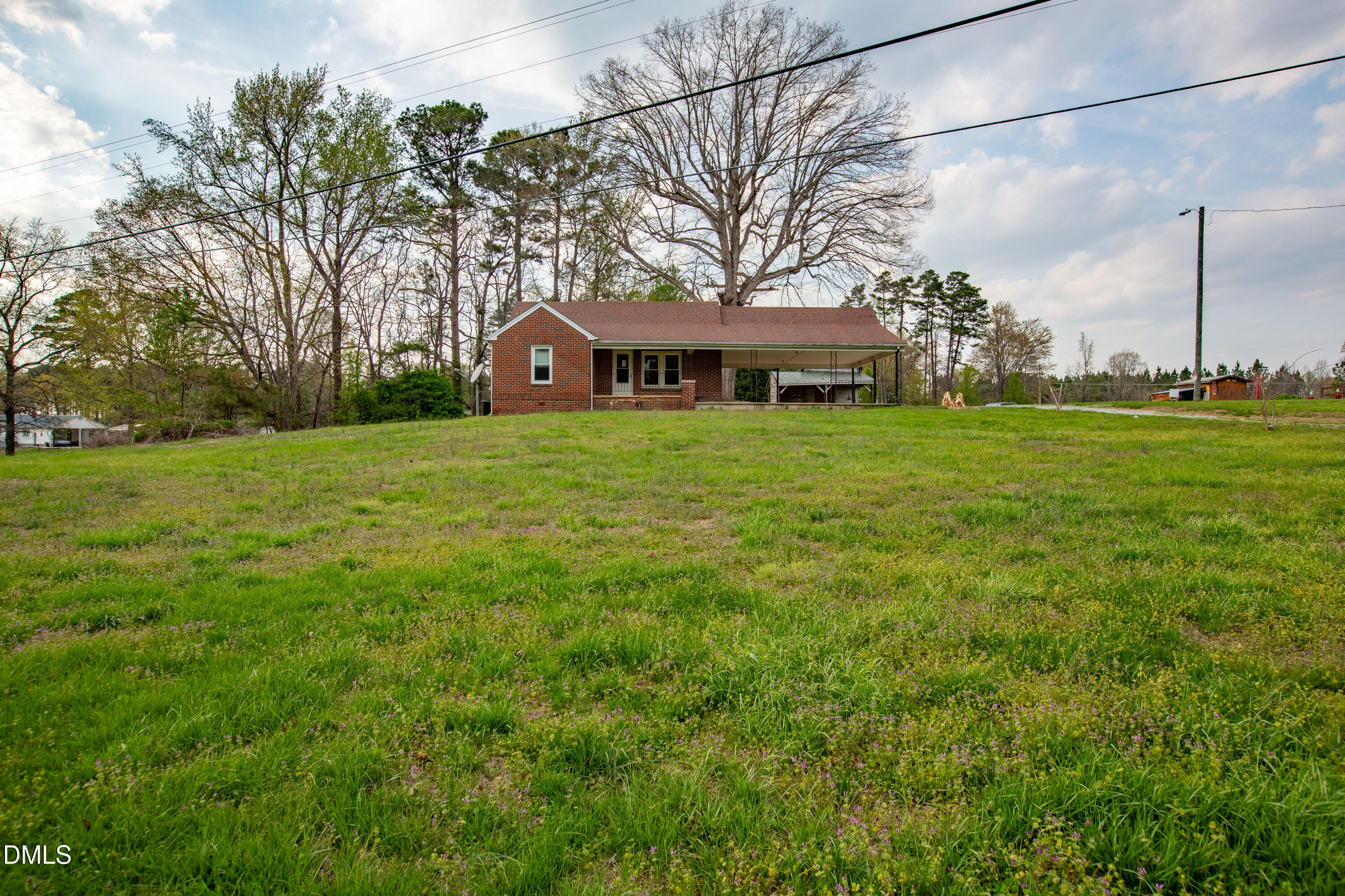 4295 Virgilina Road Roxboro, NC 27574 - Photo 2 of 46 a view of a big yard next to a house