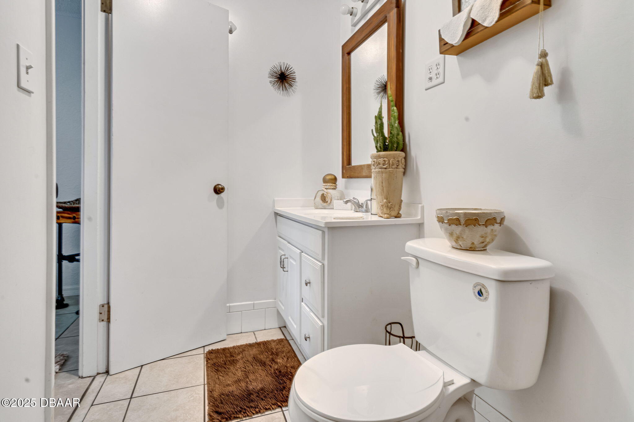 2439 Old Samsula Road Port Orange, FL 32128 - Photo 19 of 35 a bathroom with a sink a toilet and a mirror