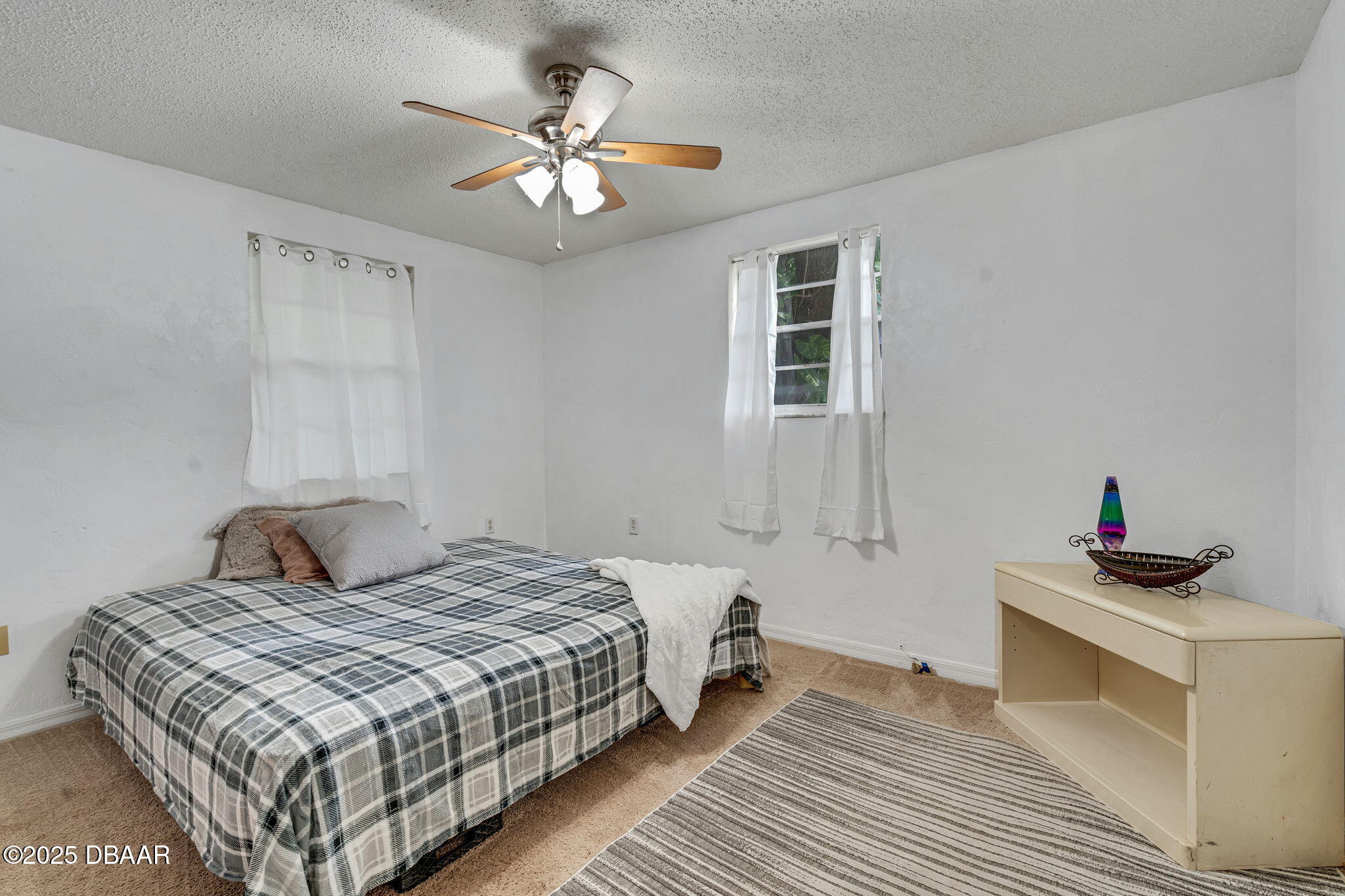 2439 Old Samsula Road Port Orange, FL 32128 - Photo 23 of 35 a bedroom with a bed and a chandelier