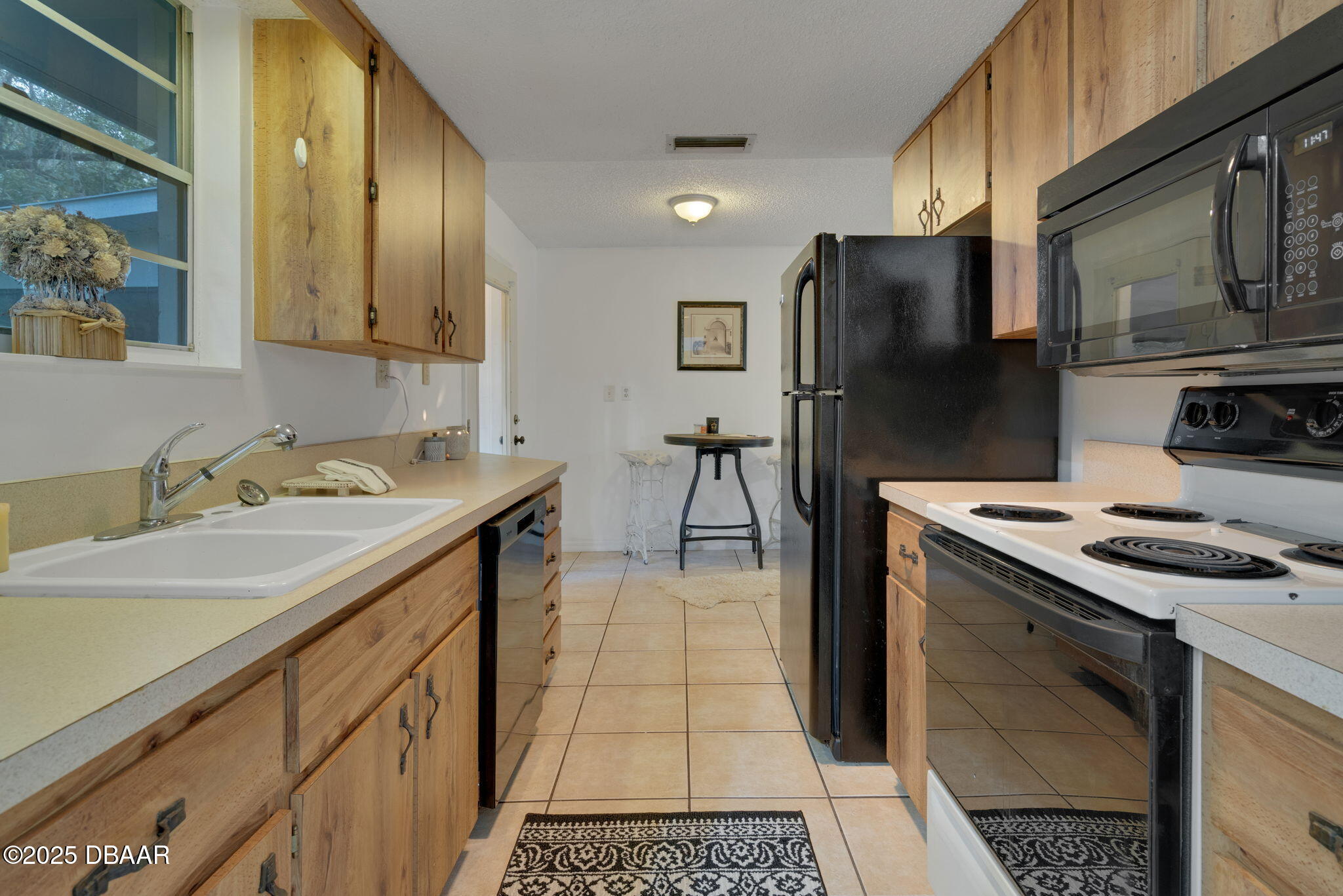 2439 Old Samsula Road Port Orange, FL 32128 - Photo 30 of 35 a kitchen with a sink stove and refrigerator