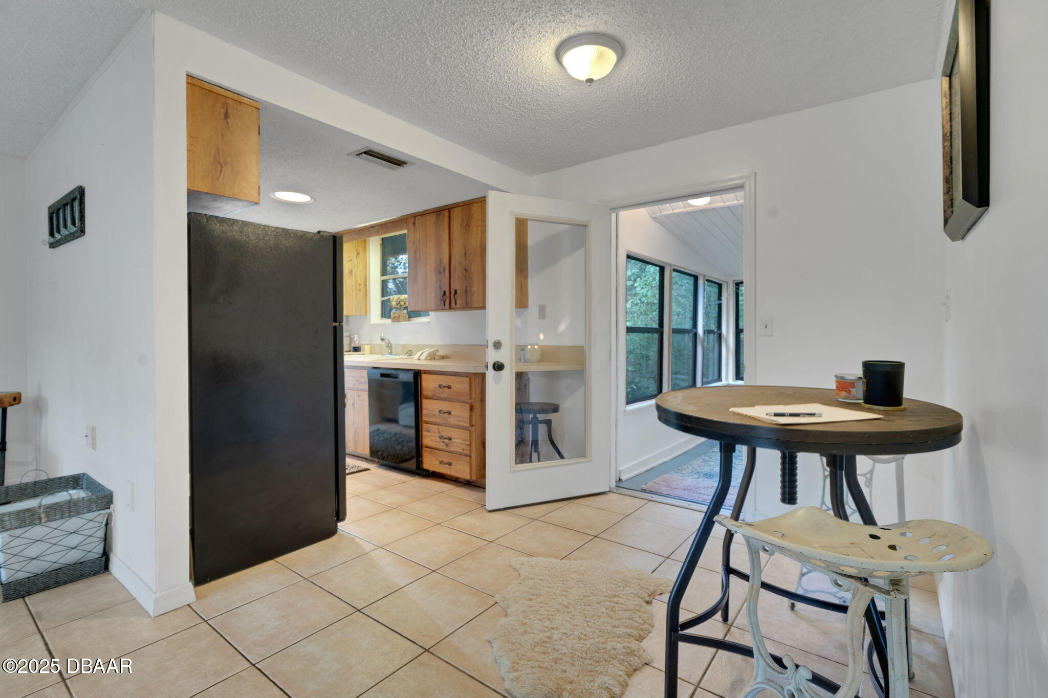 2439 Old Samsula Road Port Orange, FL 32128 - Photo 32 of 35 a kitchen with stainless steel appliances kitchen island a table chairs in it and wooden floors