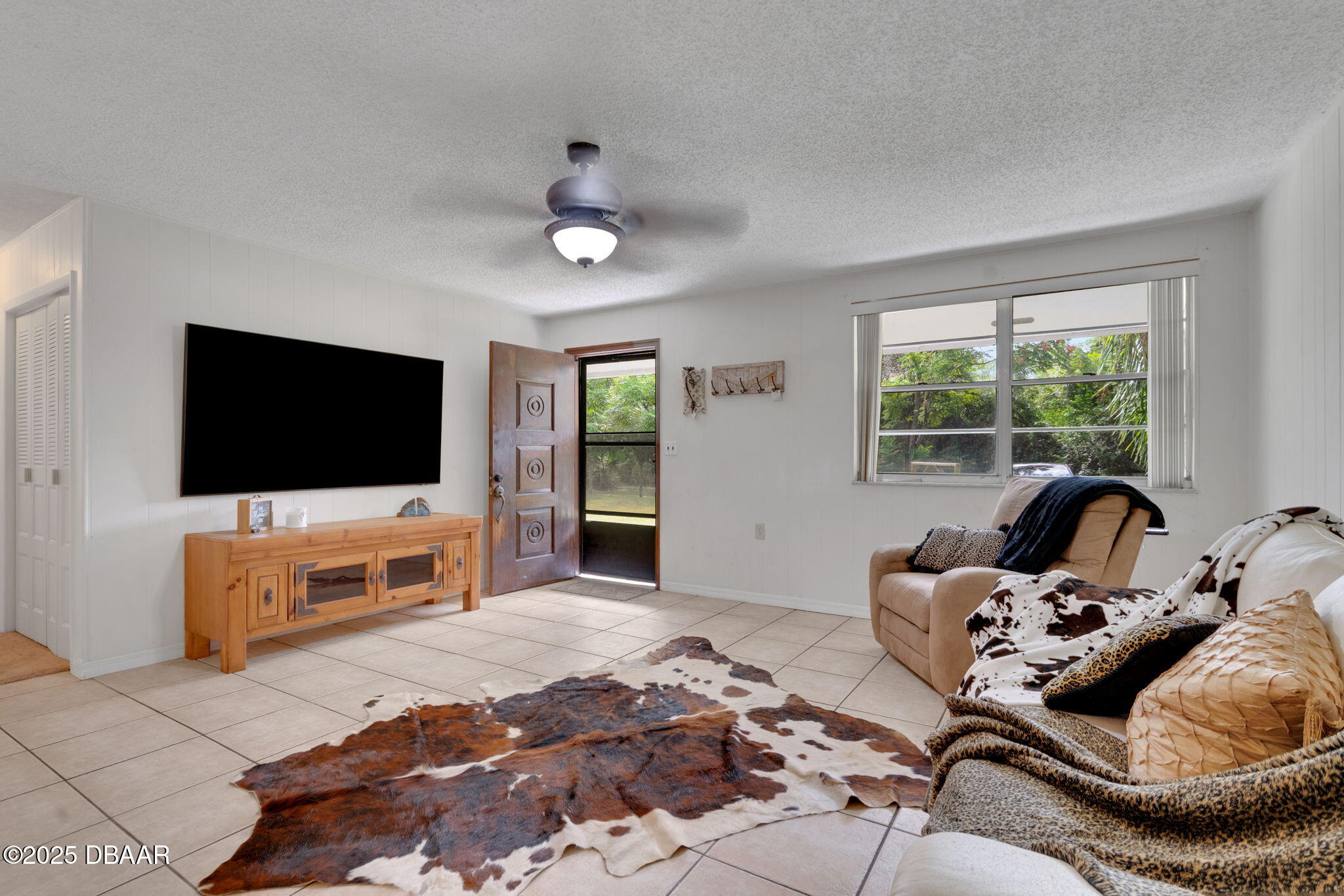 2439 Old Samsula Road Port Orange, FL 32128 - Photo 35 of 35 a bedroom with furniture and a flat screen tv