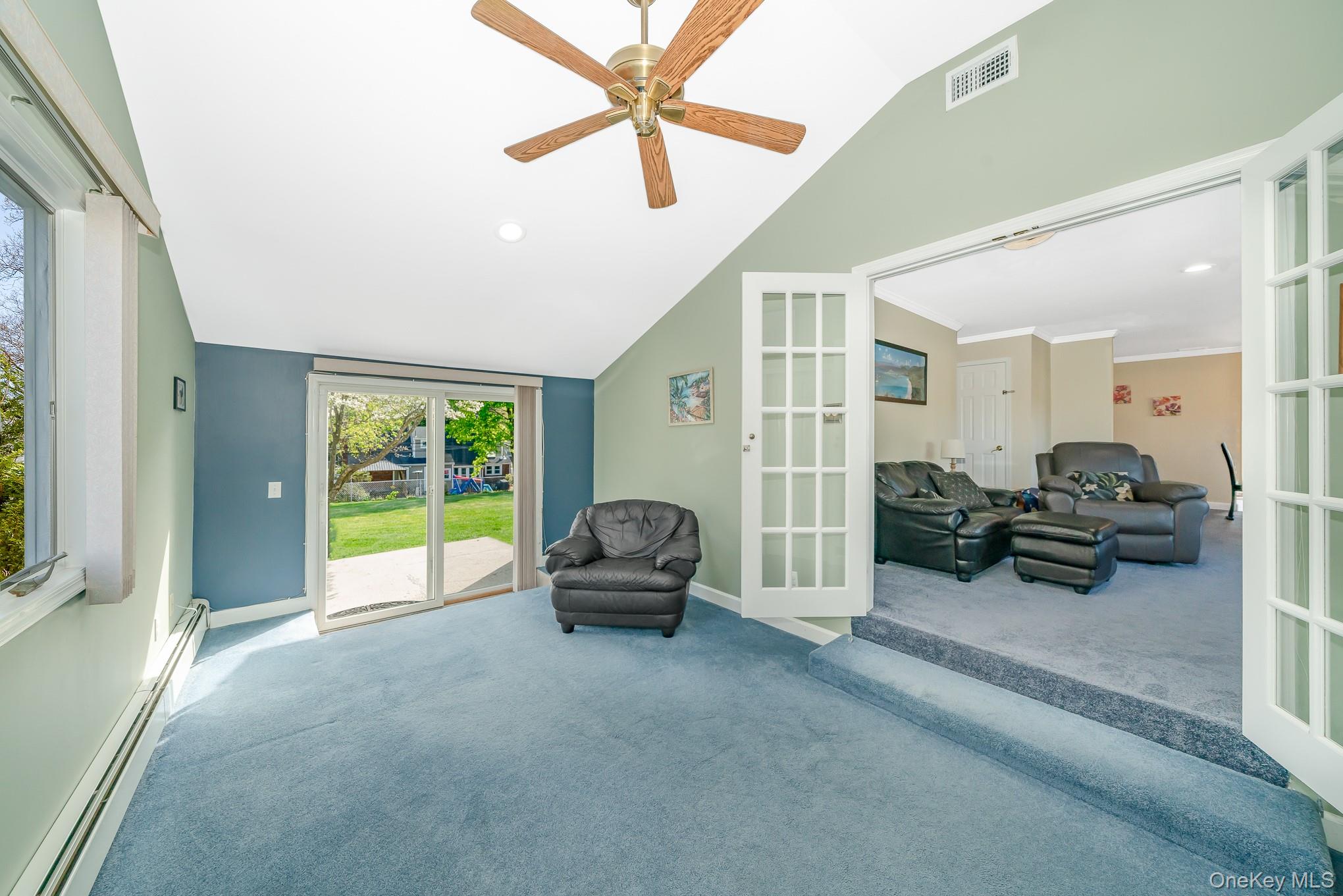 18 Byron Road Commack, NY 11725 - Photo 17 of 32 Vaulted ceiling room with light blue carpeting and a ceiling fan
