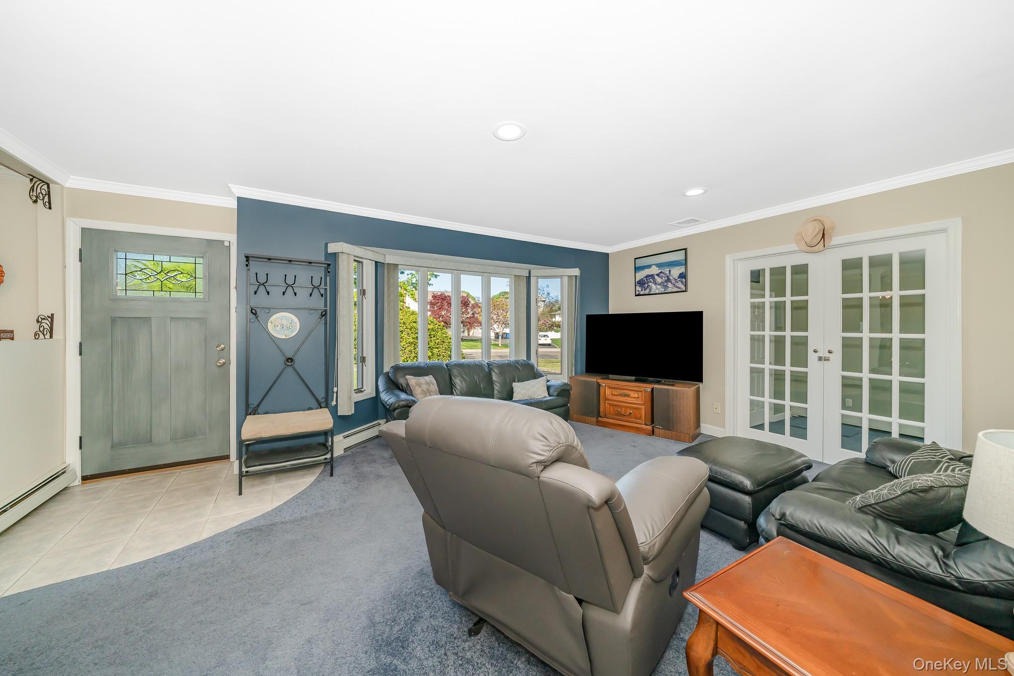 18 Byron Road Commack, NY 11725 - Photo 9 of 32 Spacious living area featuring a bay window, recessed lighting, and crown molding