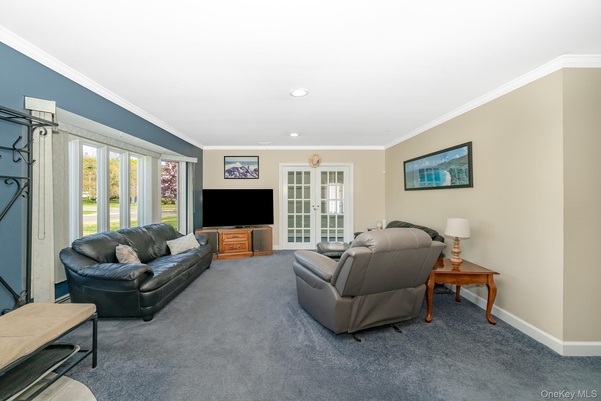 18 Byron Road Commack, NY 11725 - Photo 10 of 32 Living area with bay window, dual French doors to den - recessed lighting, crown molding, and plush carpeting