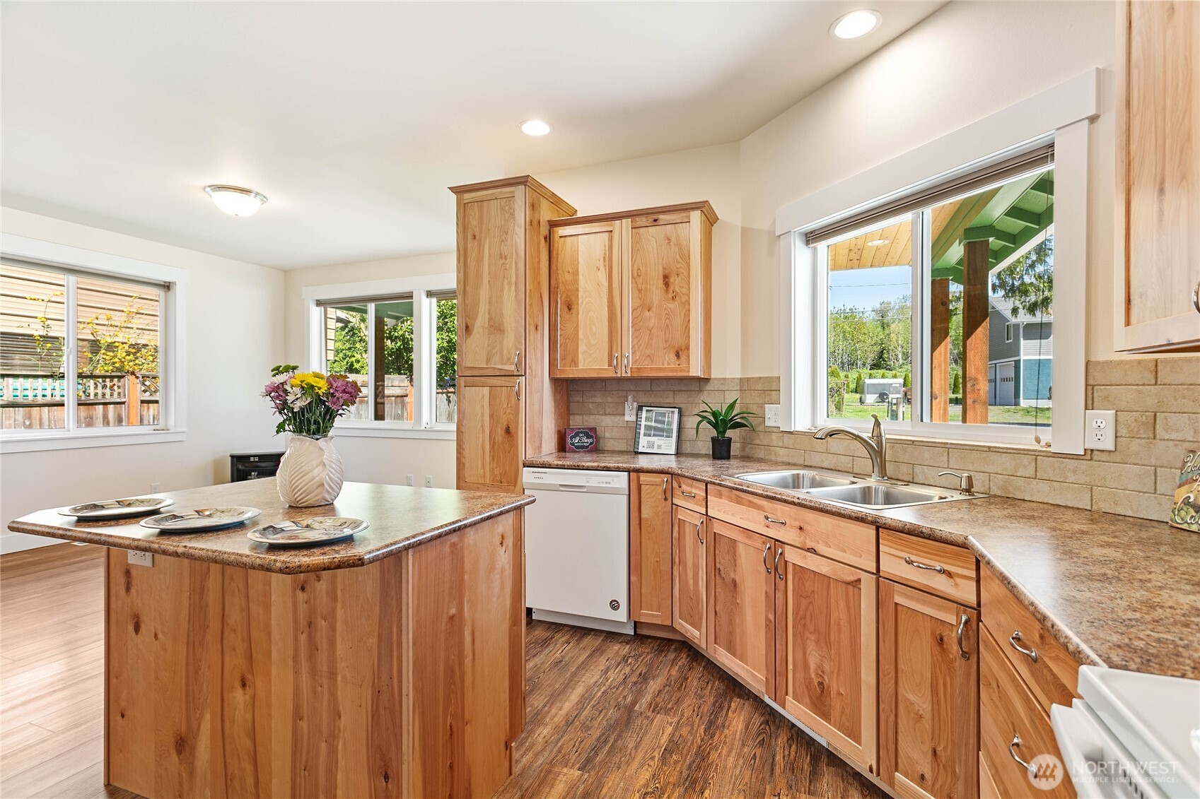 4597 Orcas Way Ferndale, WA 98248 - Photo 11 of 40 a kitchen with stainless steel appliances granite countertop a stove a sink dishwasher and a refrigerator with wooden floor