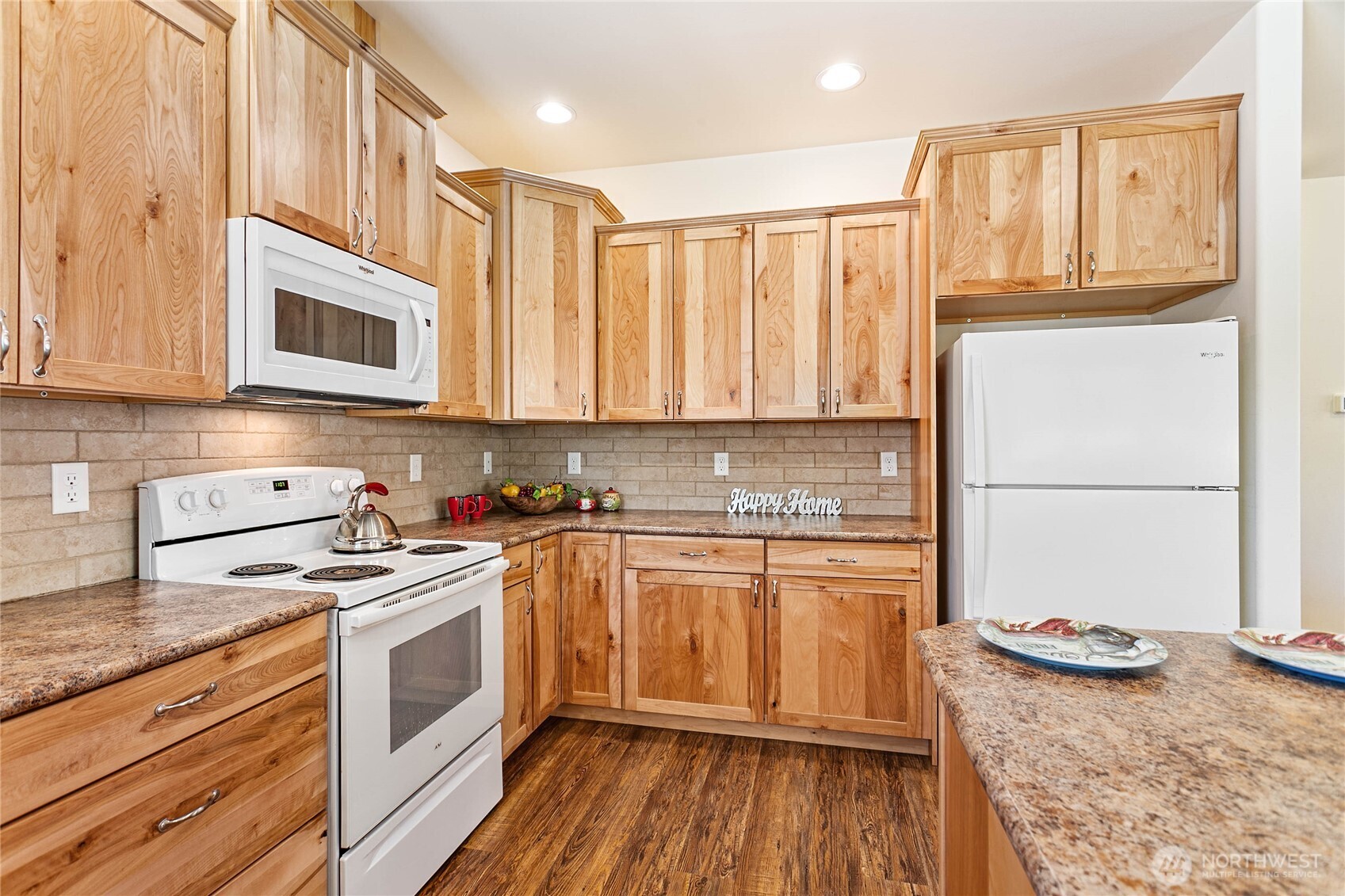 4597 Orcas Way Ferndale, WA 98248 - Photo 12 of 40 a kitchen with stainless steel appliances granite countertop a stove a sink and a refrigerator