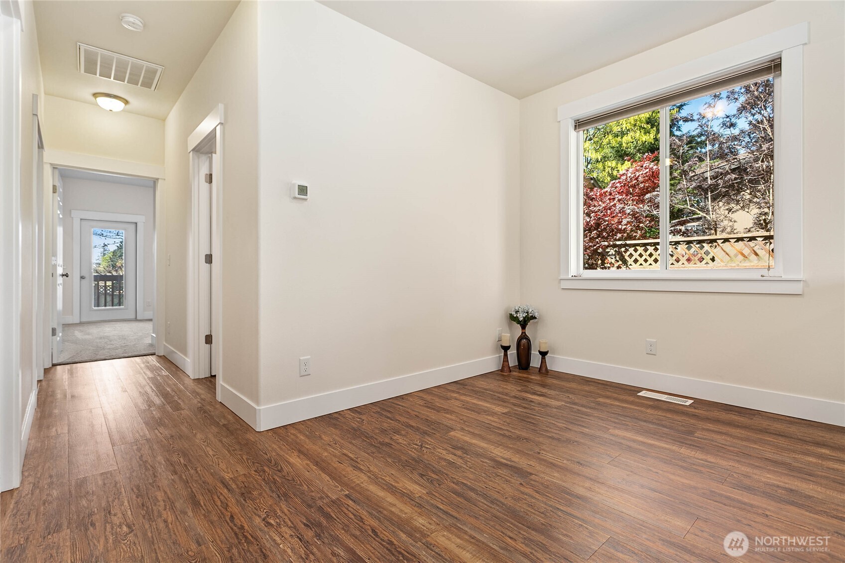 4597 Orcas Way Ferndale, WA 98248 - Photo 14 of 40 a view of an empty room with wooden floor and a window