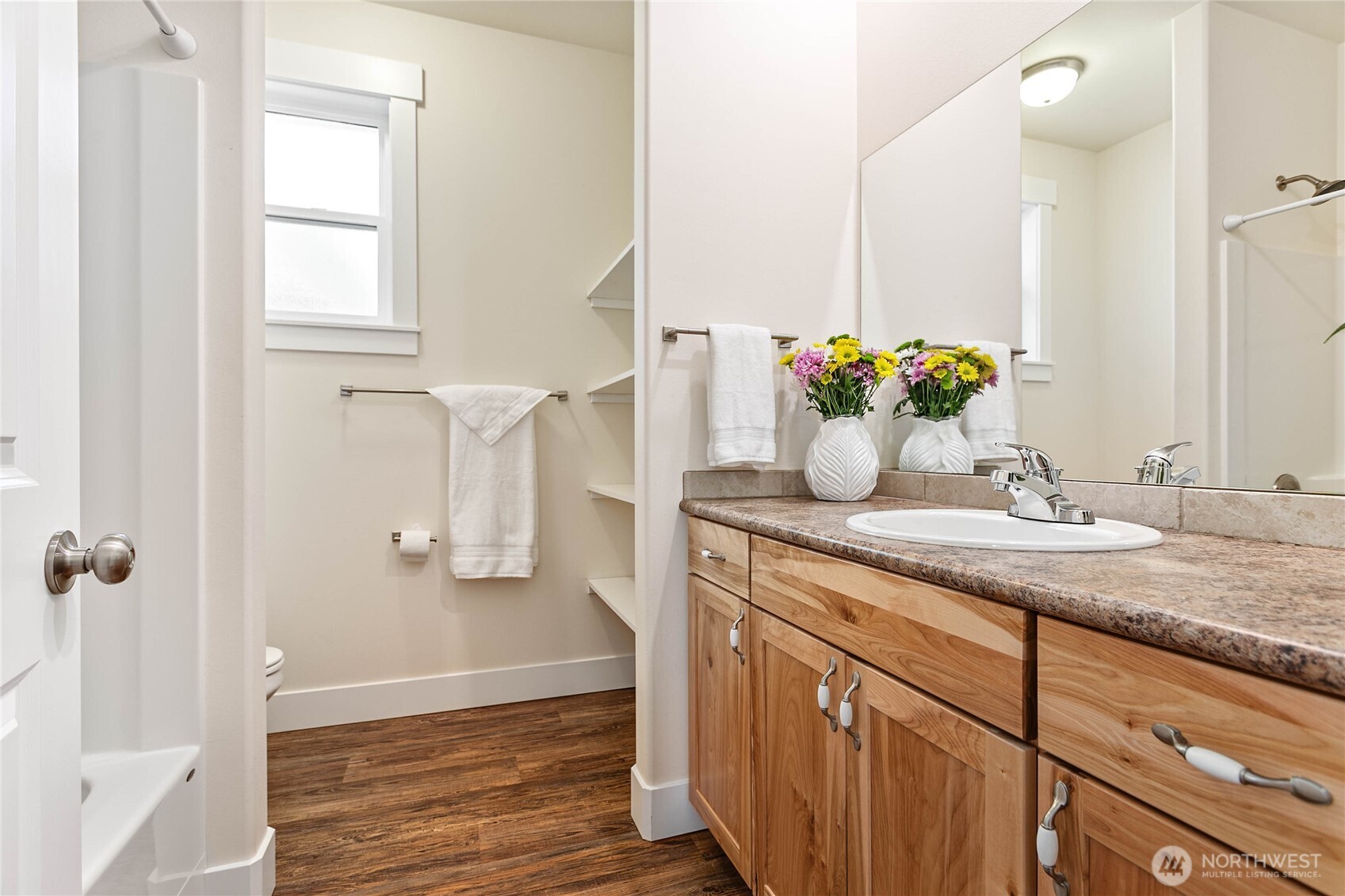 4597 Orcas Way Ferndale, WA 98248 - Photo 18 of 40 a bathroom with a granite countertop sink a mirror and a shower