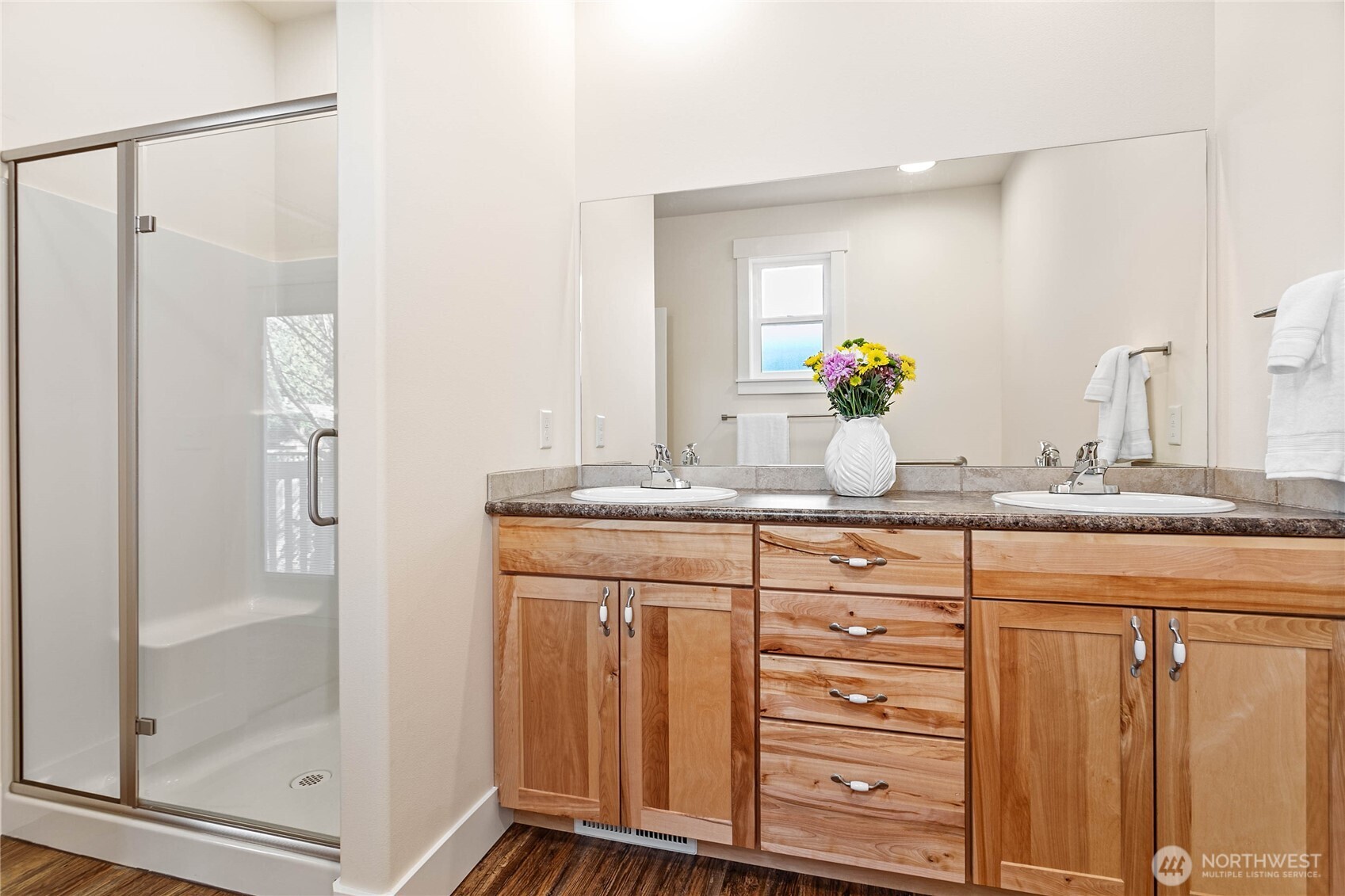 4597 Orcas Way Ferndale, WA 98248 - Photo 25 of 40 a bathroom with a granite countertop sink a mirror a vanity and a shower