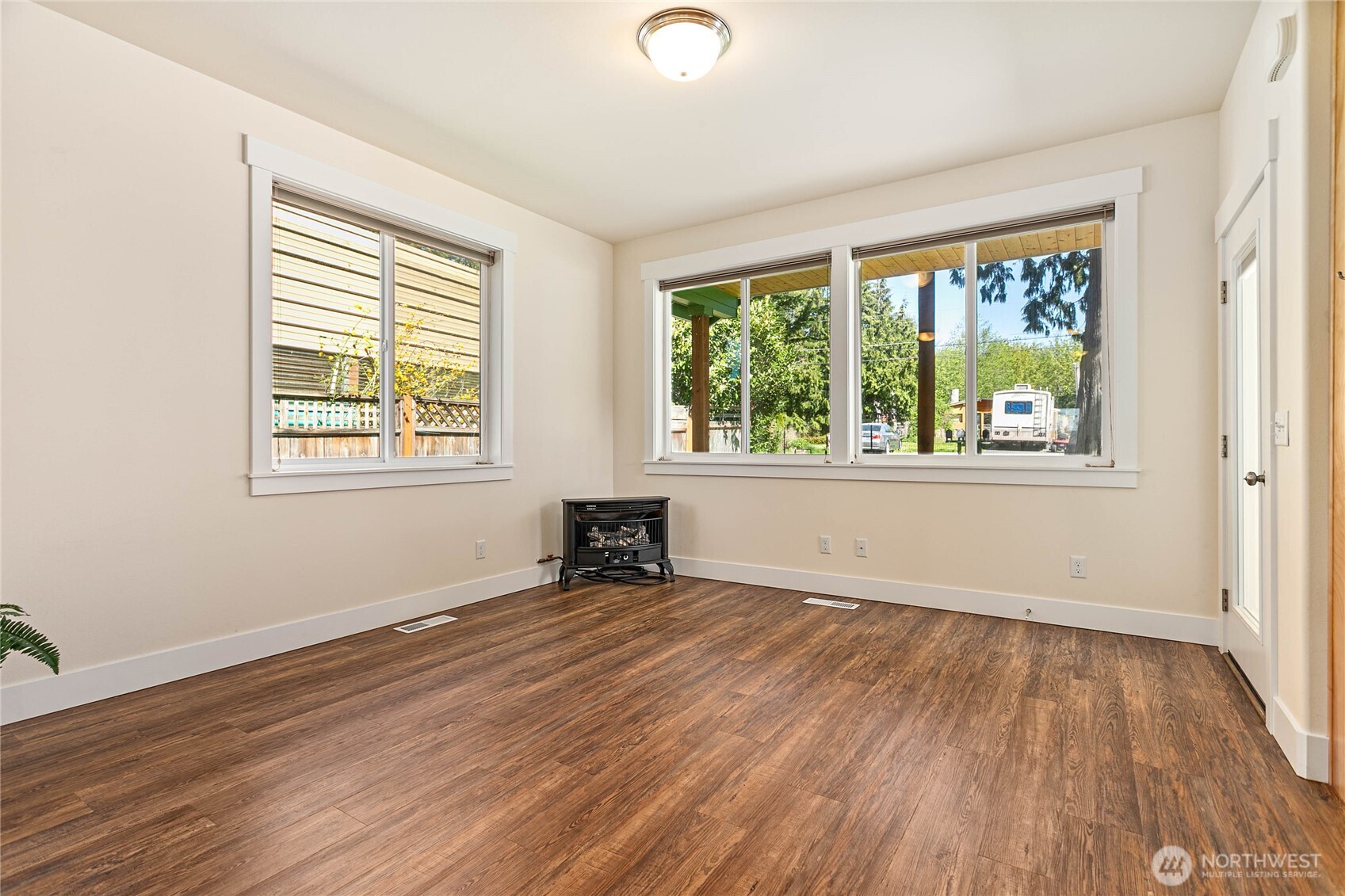 4597 Orcas Way Ferndale, WA 98248 - Photo 6 of 40 a view of an empty room with wooden floor and a window