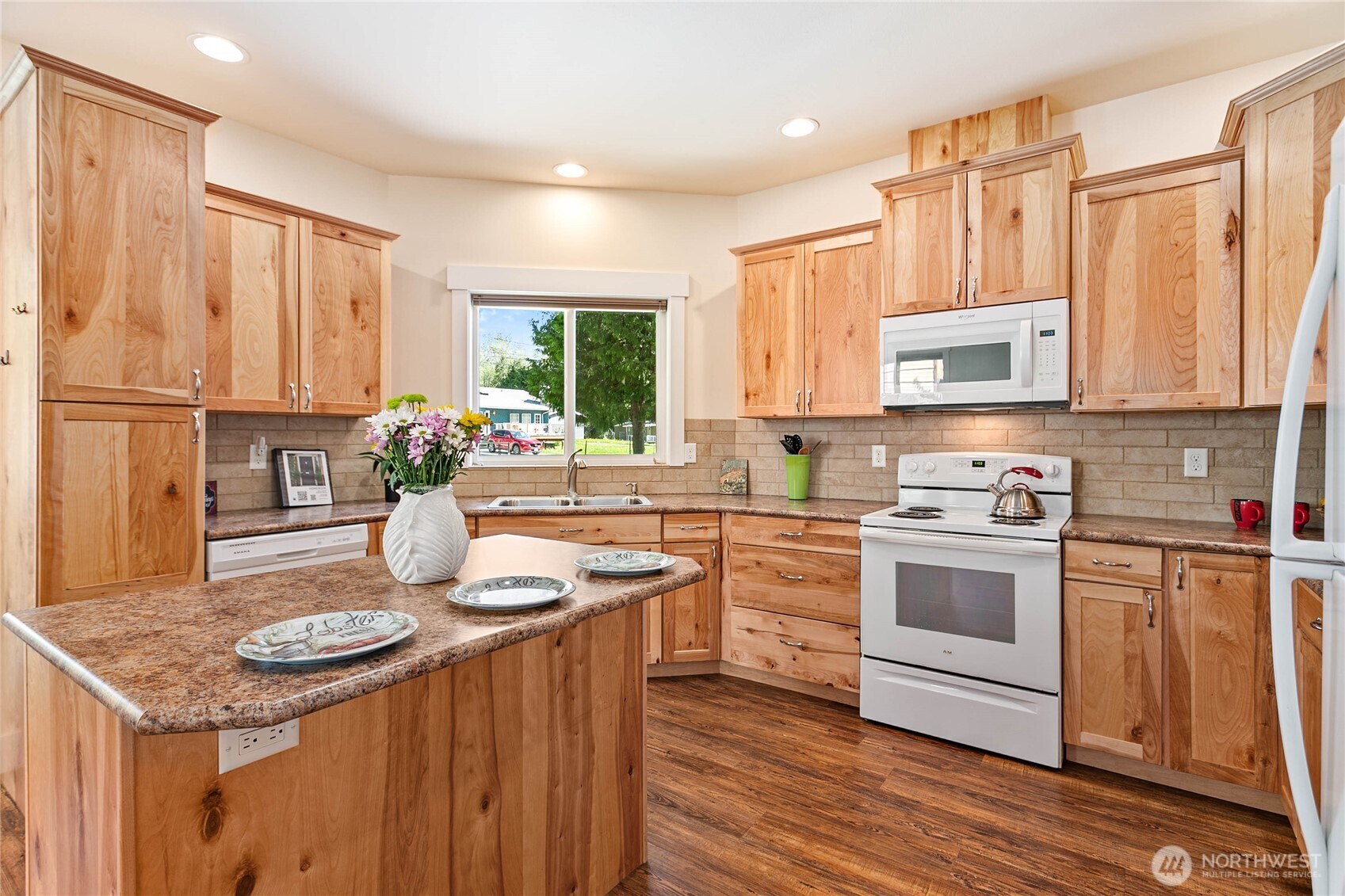 4597 Orcas Way Ferndale, WA 98248 - Photo 9 of 40 a kitchen with stainless steel appliances granite countertop a stove a sink dishwasher and a refrigerator with wooden floor