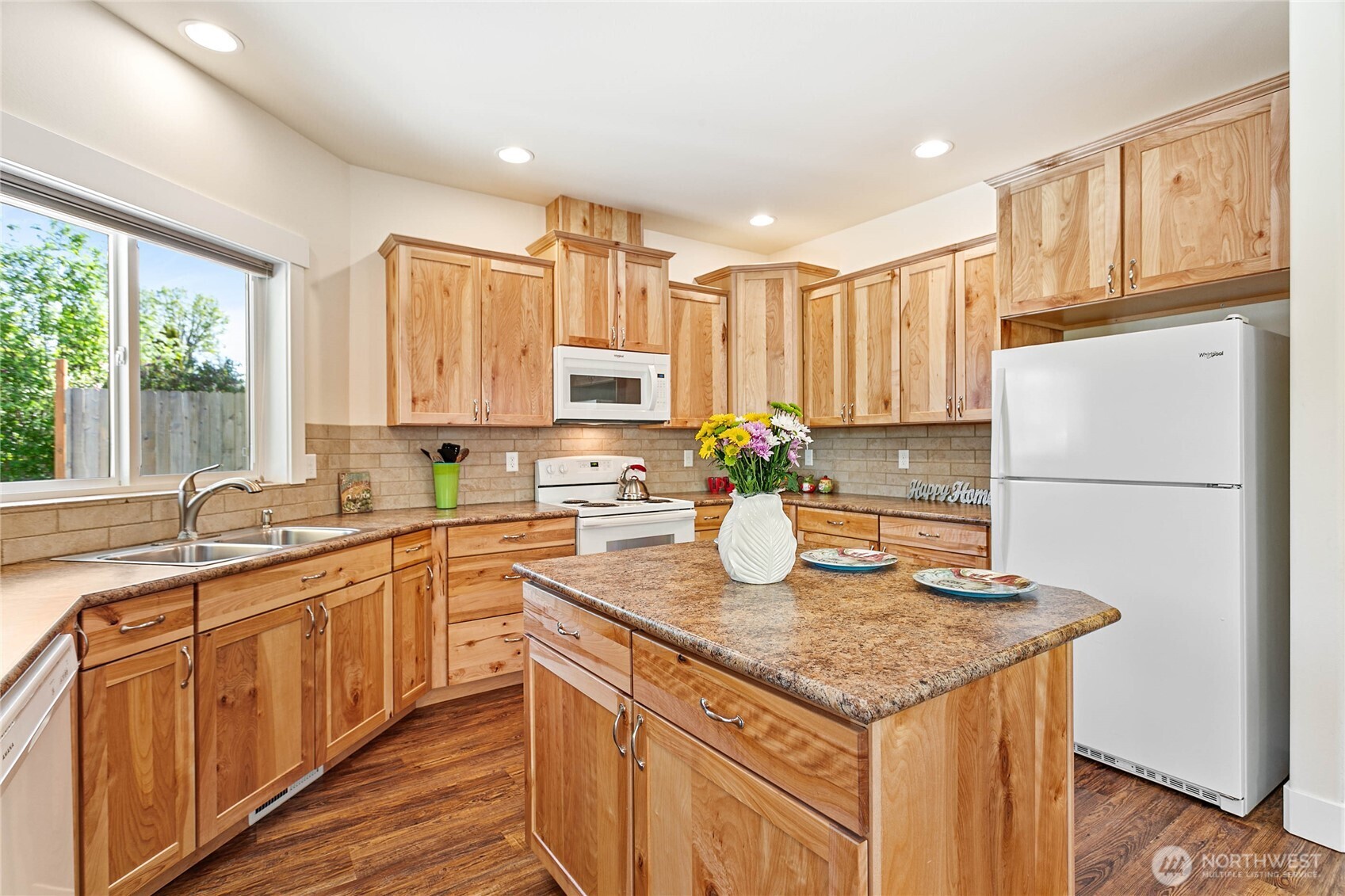 4597 Orcas Way Ferndale, WA 98248 - Photo 10 of 40 a kitchen with stainless steel appliances granite countertop a sink a stove and a refrigerator