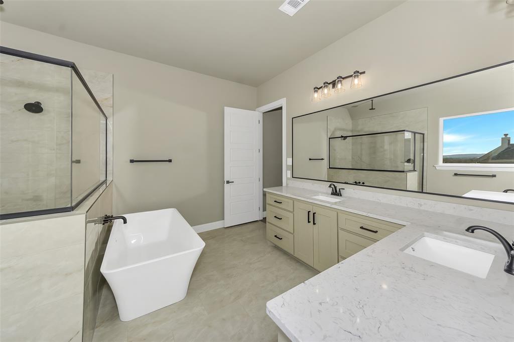 1057 Vh Ranch Poolville, TX 76487 - Photo 18 of 33 a spacious bathroom with a tub sink and mirror