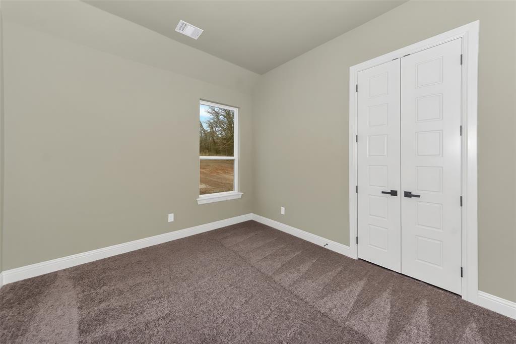 1057 Vh Ranch Poolville, TX 76487 - Photo 25 of 33 a view of an empty room with window and closet area