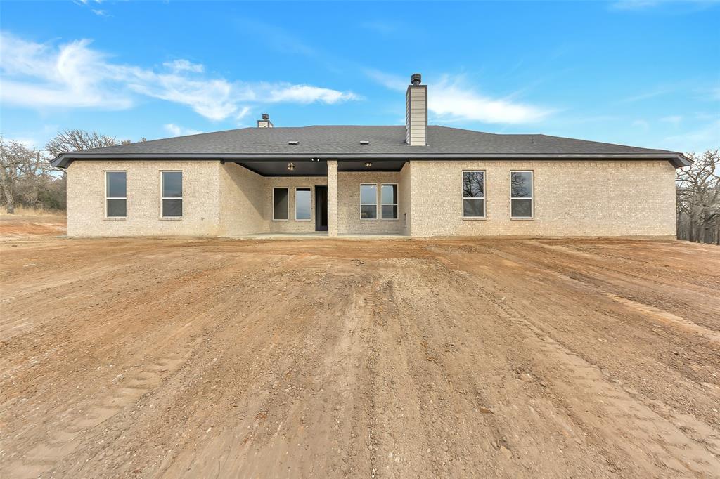 1057 Vh Ranch Poolville, TX 76487 - Photo 31 of 33 a front view of a house with a garage