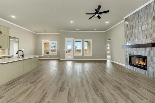 a view of an empty room with a window and fireplace