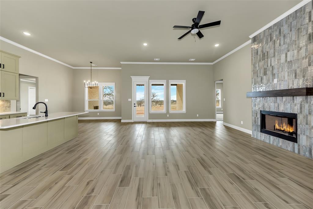 1057 Vh Ranch Poolville, TX 76487 - Photo 6 of 33 a view of an empty room with a window and fireplace