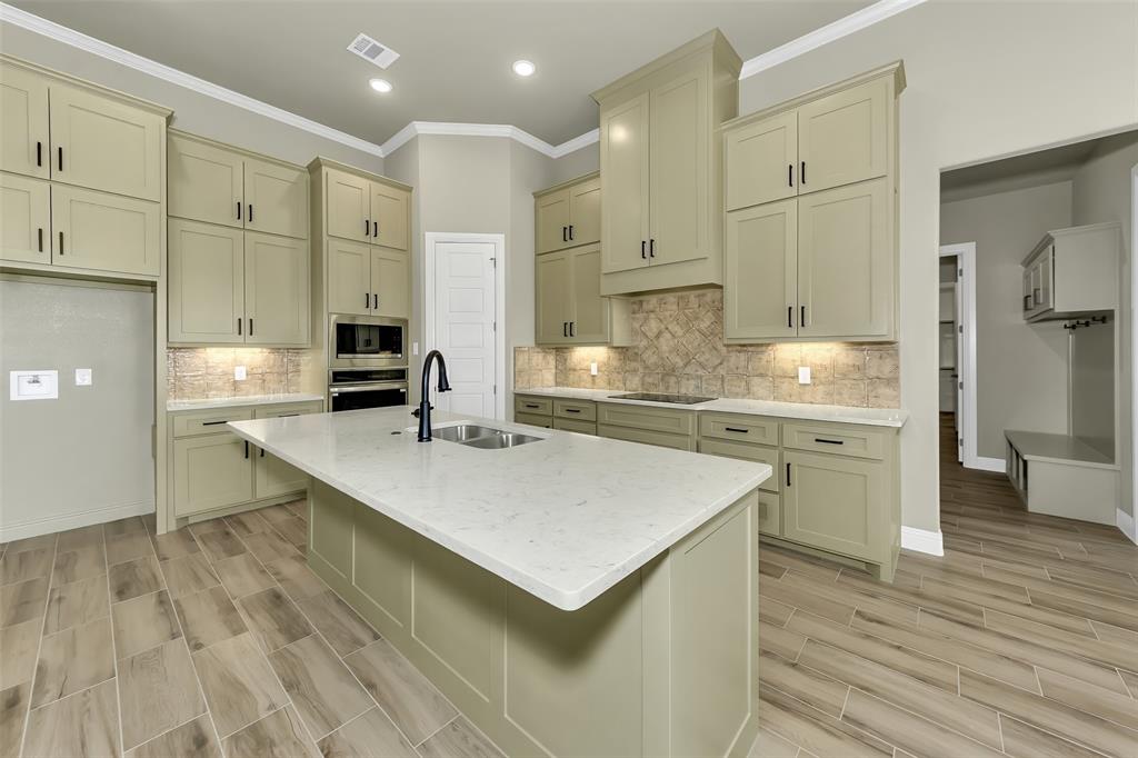 1057 Vh Ranch Poolville, TX 76487 - Photo 8 of 33 a kitchen with a sink a stove a refrigerator and white cabinets