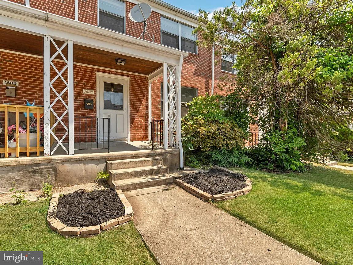 1804 Winford Road Baltimore, MD 21239 - Photo 1 of 17 Charming brick facade with lush greenery.