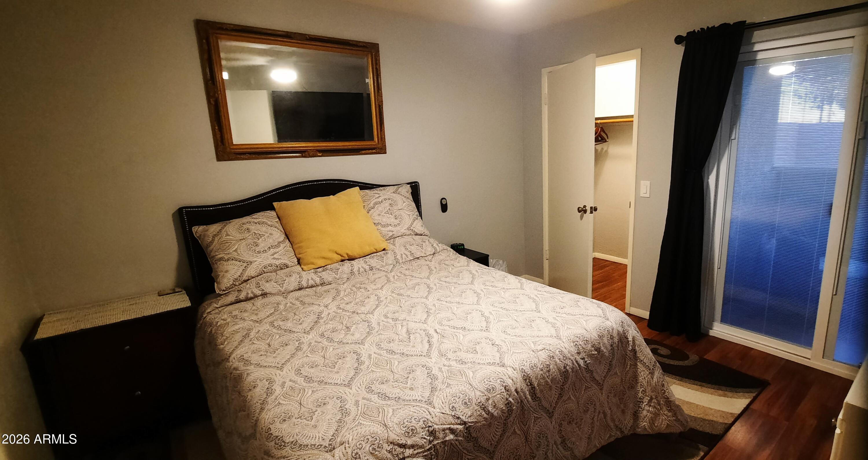 12221 West Bell Road, Unit 149 Surprise, AZ 85378 - Photo 12 of 28 a bedroom with a bed and a mirror