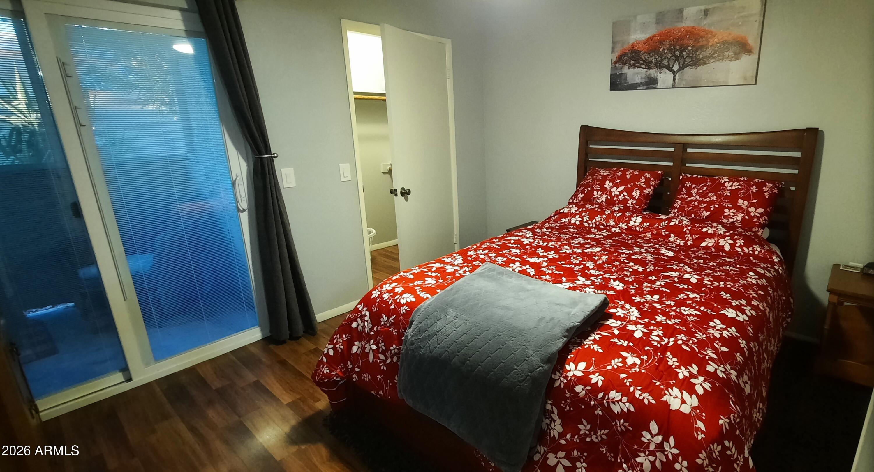 12221 West Bell Road, Unit 149 Surprise, AZ 85378 - Photo 14 of 28 a bedroom with a bed and a mirror