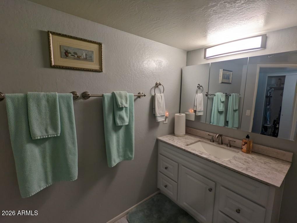 12221 West Bell Road, Unit 149 Surprise, AZ 85378 - Photo 18 of 28 a bathroom with a double vanity sink and mirror