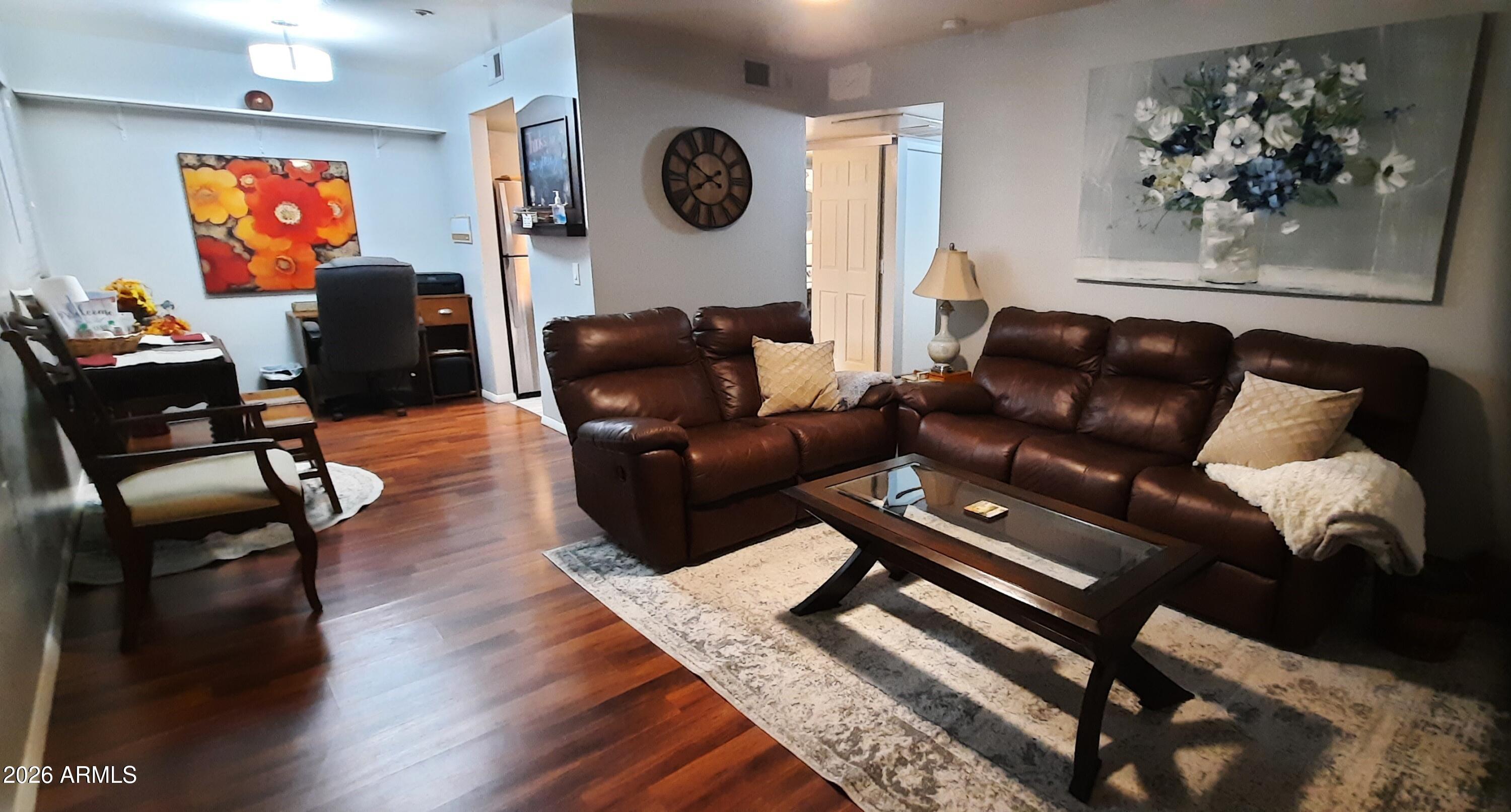 12221 West Bell Road, Unit 149 Surprise, AZ 85378 - Photo 2 of 28 a living room with furniture and a flat screen tv
