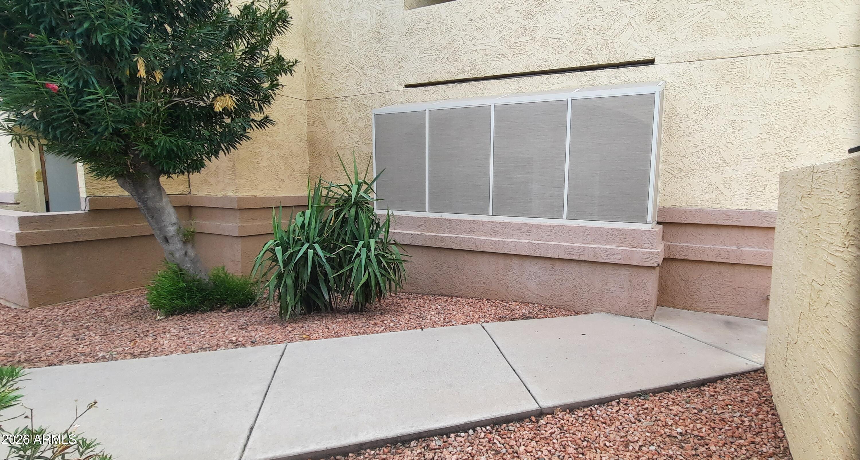 12221 West Bell Road, Unit 149 Surprise, AZ 85378 - Photo 24 of 28 a view of house with roof and potted plants
