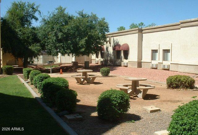 12221 West Bell Road, Unit 149 Surprise, AZ 85378 - Photo 26 of 28 a swimming pool with outdoor seating and a garden
