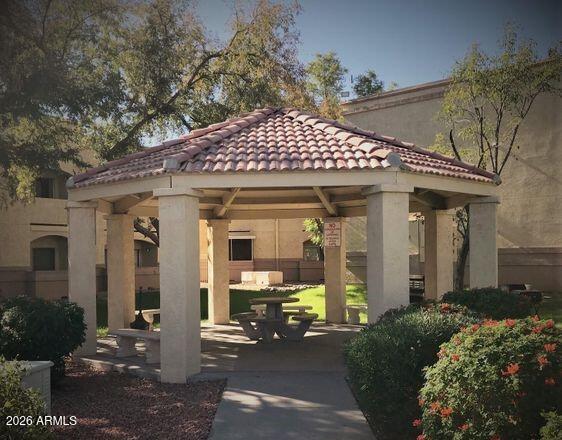 12221 West Bell Road, Unit 149 Surprise, AZ 85378 - Photo 27 of 28 a view of a house with a small yard plants and large tree