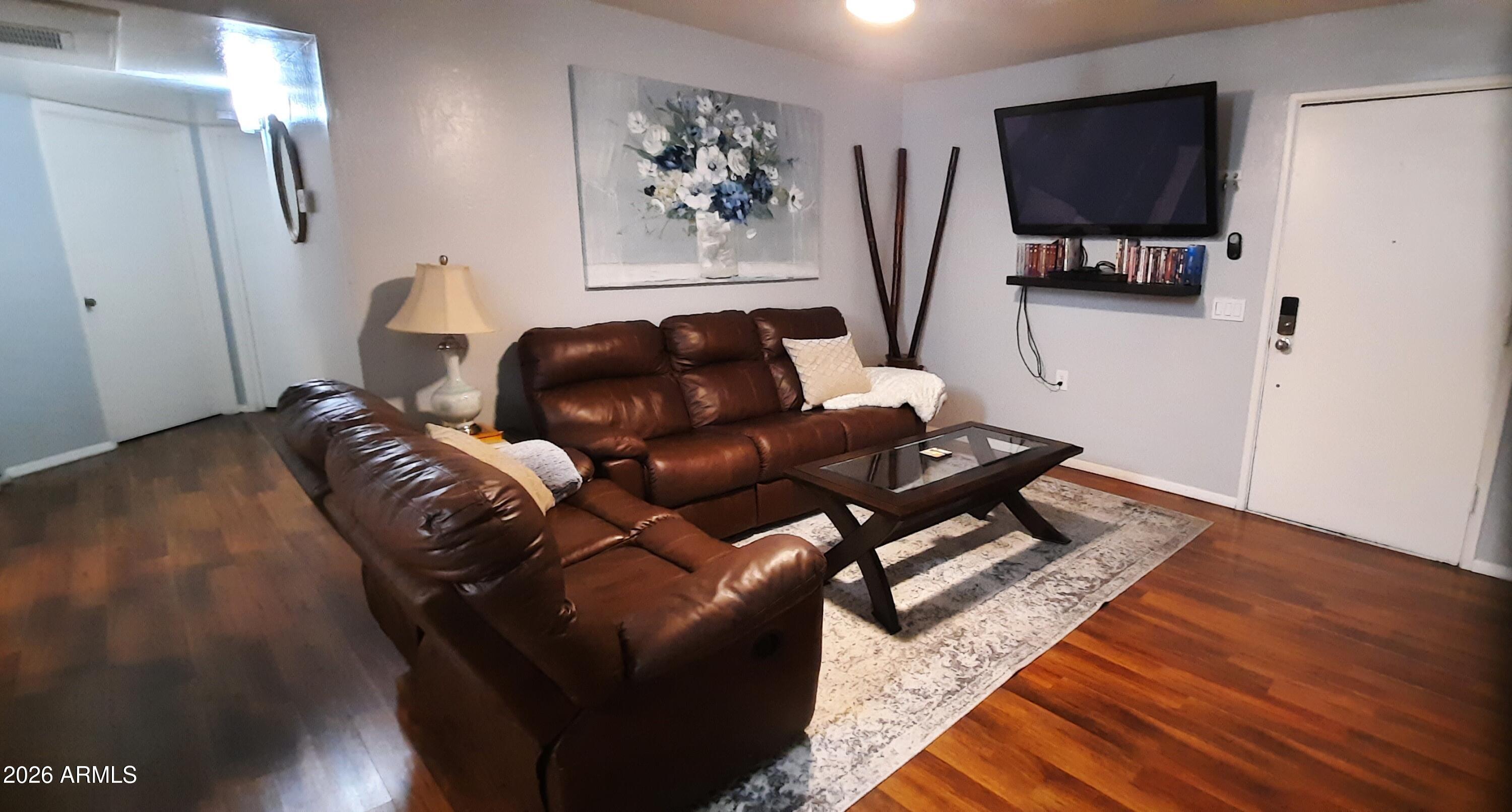 12221 West Bell Road, Unit 149 Surprise, AZ 85378 - Photo 3 of 28 a living room with furniture and a flat screen tv