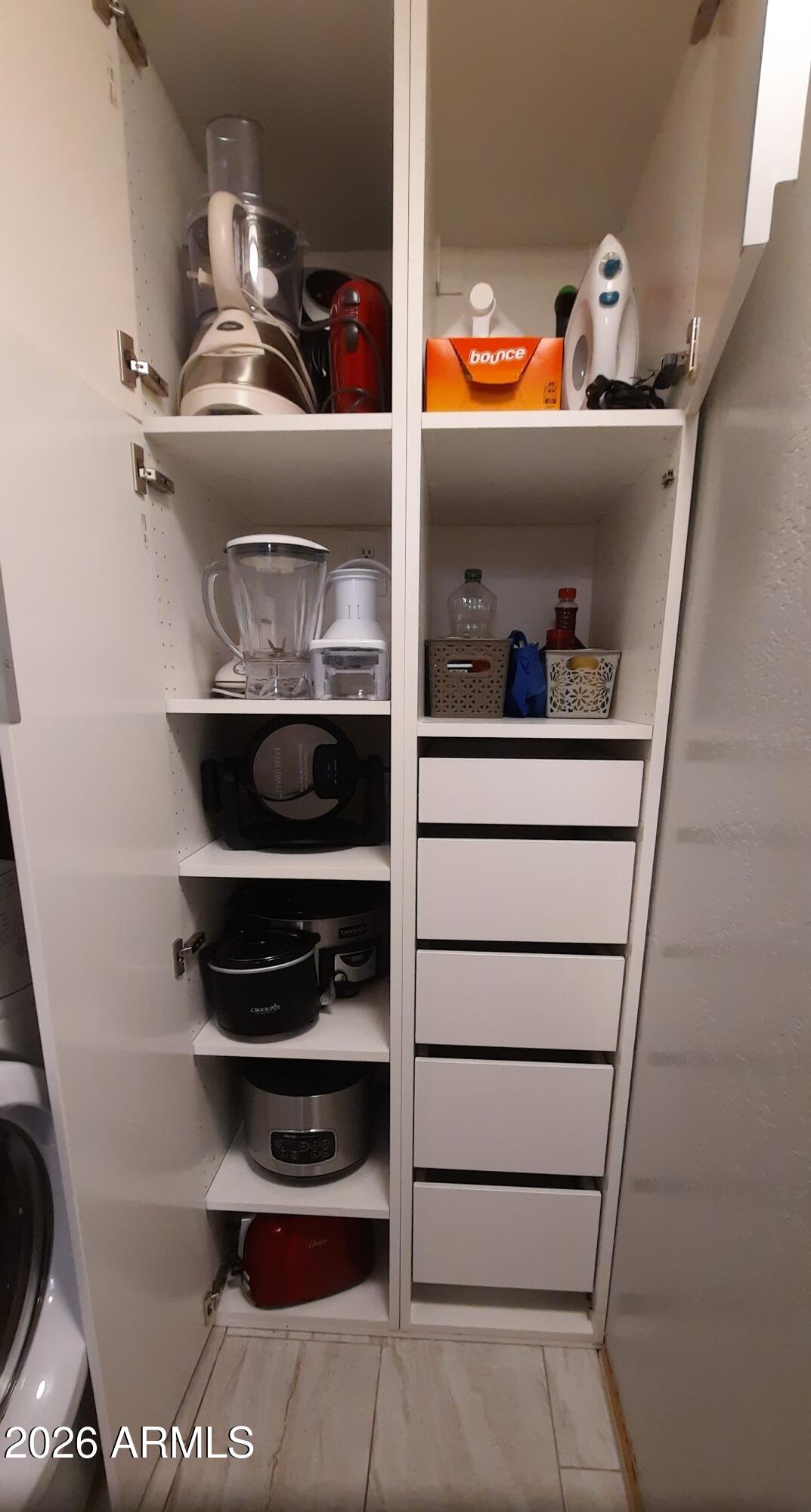 12221 West Bell Road, Unit 149 Surprise, AZ 85378 - Photo 9 of 28 a storage room with stainless steel appliances and cabinets