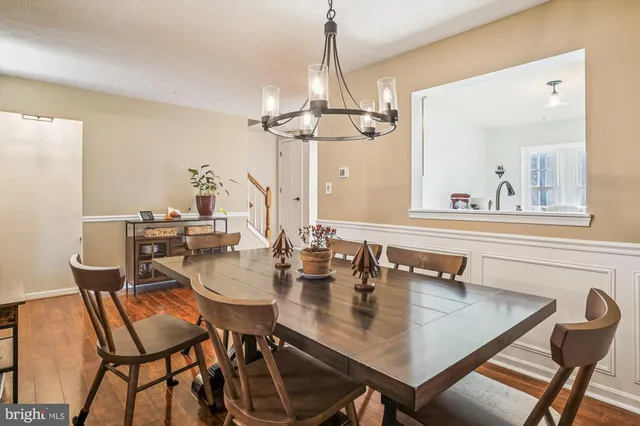 a view of a dining room with furniture and a chandelier