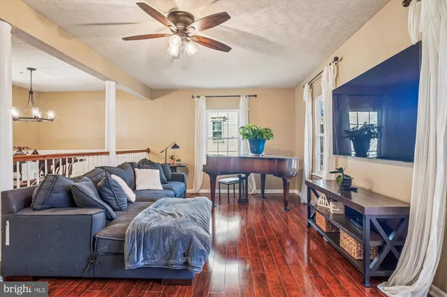 a living room with furniture and a wooden floor
