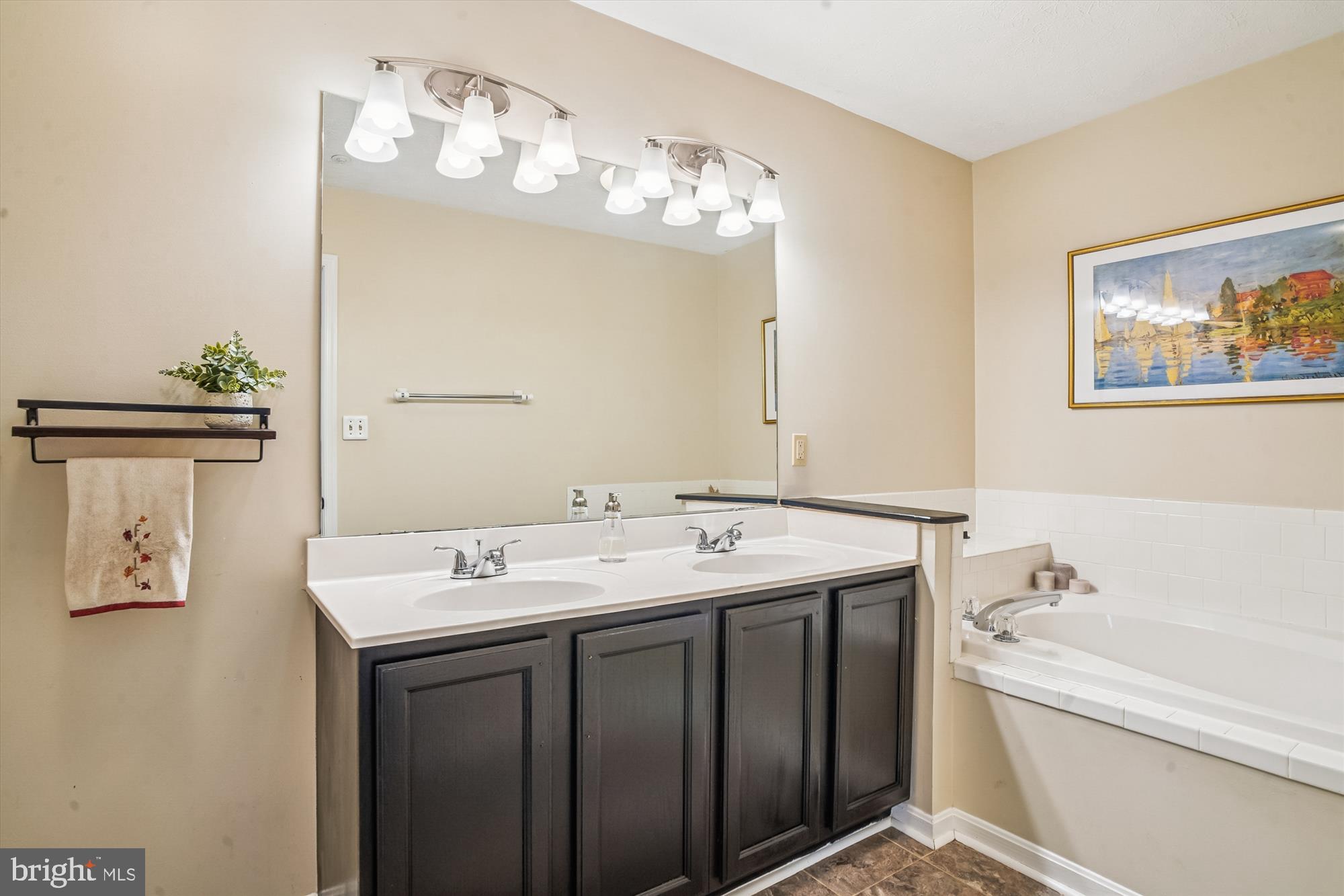 2542 Windy Oak Court Crofton, MD 21114 - Photo 21 of 37 a spacious bathroom with a granite countertop sink a large mirror and a bathtub