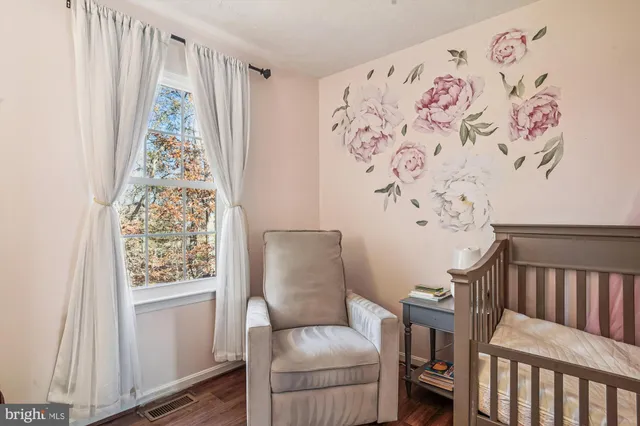 a bedroom with a bed and a window with rug