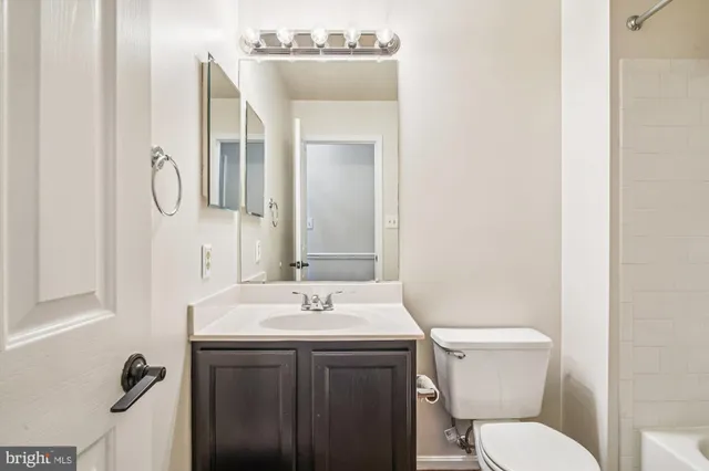 a bathroom with a sink a toilet and mirror