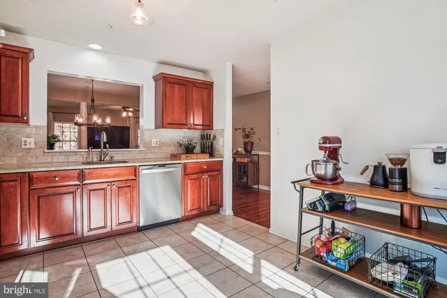 a open kitchen with stainless steel appliances granite countertop a sink dishwasher stove and cabinets