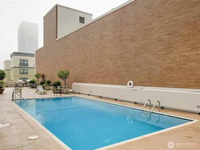 a view of a swimming pool with outdoor seating